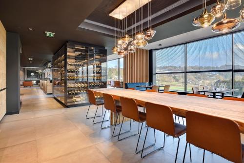 a large dining room with a long table and chairs at R hotel experiences in Sougné-Remouchamps
