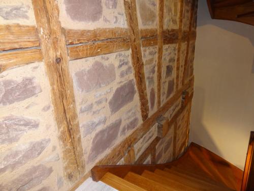 a wooden box with a stone wall at My Sweet Homes - Le 15 in Colmar