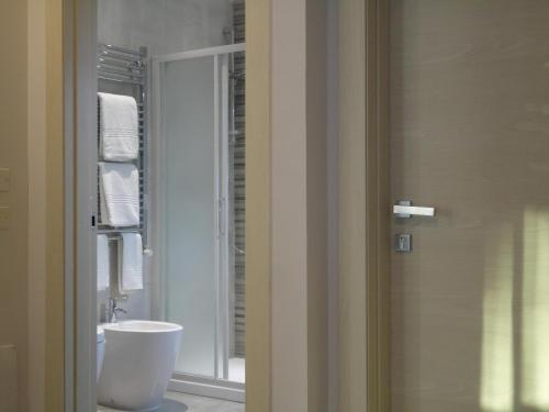 a bathroom with a white sink and a mirror at The Flat 233 in Tavarnuzze