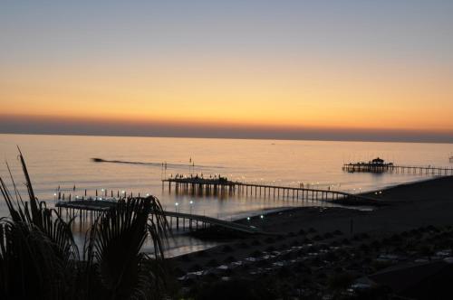 a view of the ocean at sunset with a pier at Anitas Hotel in Konaklı