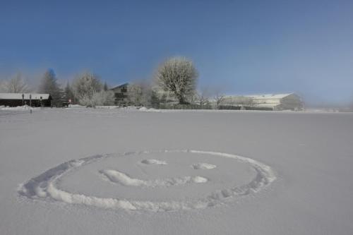 a peace sign in the snow on a field at Farbinger Hof in Bernau am Chiemsee