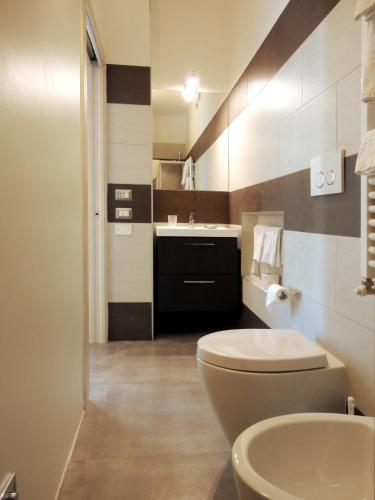 a bathroom with a toilet and a sink at The Flat 233 in Tavarnuzze