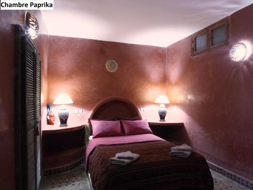 a small room with a bed and two night stands at Villa Grenadine in Essaouira