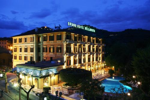 a building with a pool in front of it at night at Grand Hotel Bellavista Palace & Golf in Montecatini Terme