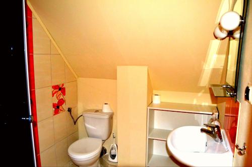 a small bathroom with a toilet and a sink at Domek u Darka in Kielce