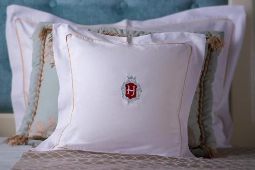 a white pillow sitting on a bed at Hotel Jarosław in Jarosław