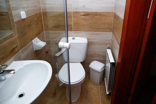 a bathroom with a toilet and a sink at Princess Apartman in Siófok