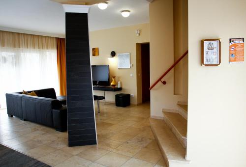a living room with a couch and a table at Princess Apartman in Siófok