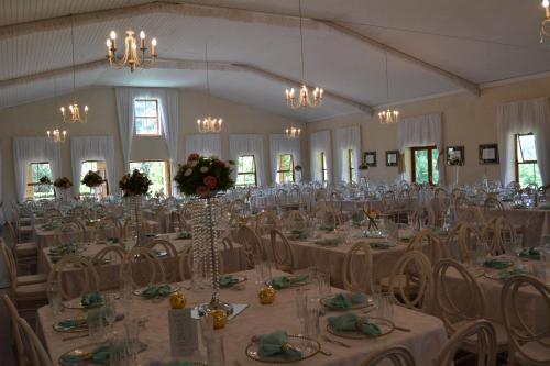 a large banquet hall with tables and chairs at Halliwell Country Inn in Howick
