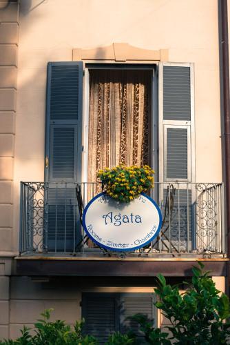 a sign on a balcony with a flower pot on it at Affittacamere Agata in Levanto