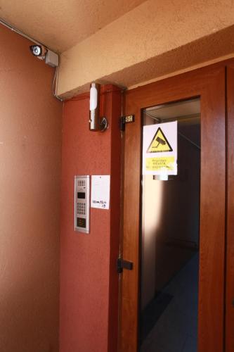 a door to a room with a hazard sign on the wall at Penthouse Renașterii Amazonia in Timişoara