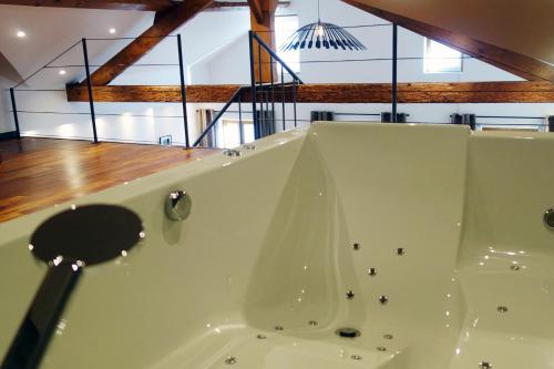 a bath tub in a room with a wooden floor at Les suites sainte claire in Annecy