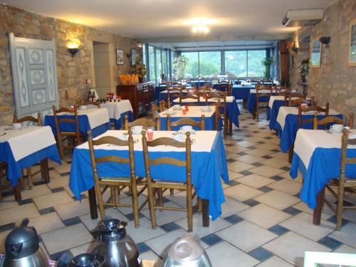 a restaurant with blue and white tables and chairs at Hotel Pikassaria in Sare