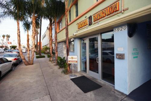 a store on a street with palm trees in front of it at Banana Bungalow Hollywood Hotel & Hostel in Los Angeles