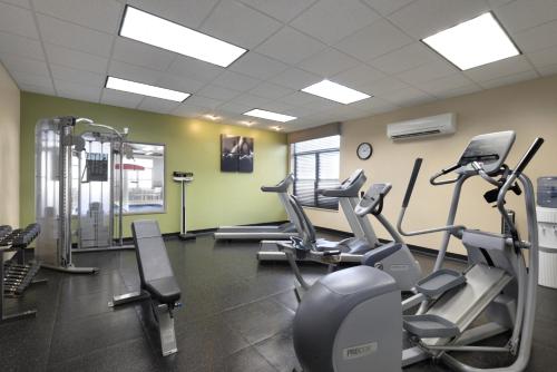 a gym with treadmills and elliptical machines at Country Inn & Suites by Radisson, Houghton, MI in Houghton
