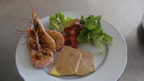 a plate of food with seafood and vegetables on a table at Hotel Pikassaria in Sare