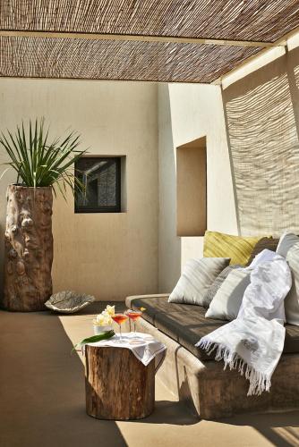 a living room with a couch and a coffee table at Sikelia Luxury Hotel in Pantelleria
