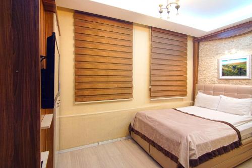 Ένα ή περισσότερα κρεβάτια σε δωμάτιο στο Kars Konak Hotel