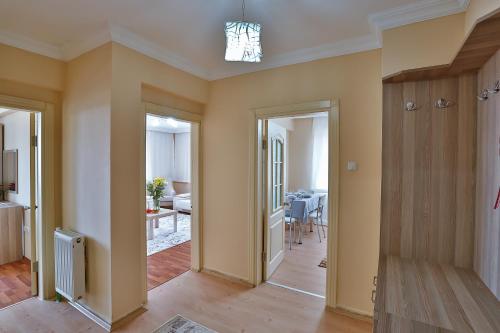 a living room with yellow walls and a dining room at Afyon Can Termal Apart in Afyon