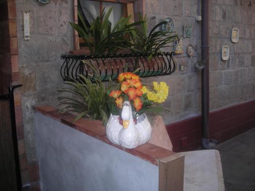 a statue of a chicken with flowers in it at B&B L'Arcobaleno in Sorrento