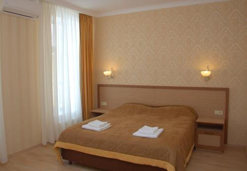 Postel nebo postele na pokoji v ubytování Staryj Kosiv