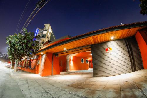 a building with two garage doors on a street at Hotel Boutique Abad in Guadalajara