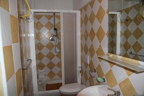 a bathroom with a shower and a toilet and a sink at Appartamento Martina in Olbia