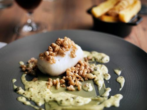 a dessert on a plate with nuts on it at The Crown in Amersham