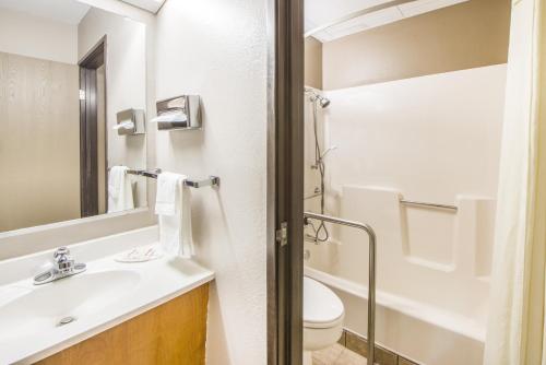 a bathroom with a sink and a toilet at Super 8 by Wyndham Nevada in Nevada