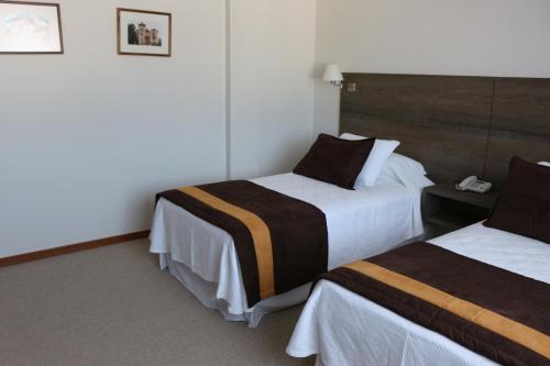 Postel nebo postele na pokoji v ubytování Conrado Hotel Osorno