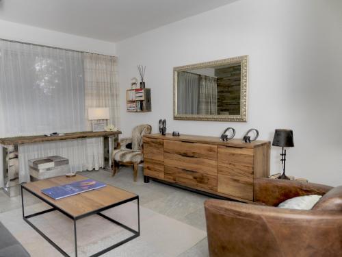 a living room with a wooden dresser and a mirror at Hausroc-Zermatt in Zermatt