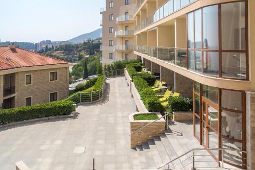 an external view of a building with a walkway at ApartHotel Belvedere Residence Becici Budva in Budva