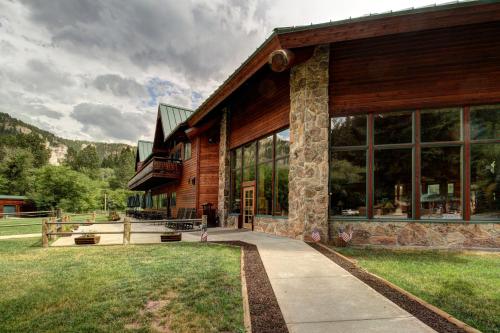 a house with a porch and a large window at Spearfish Canyon Lodge in Spearfish