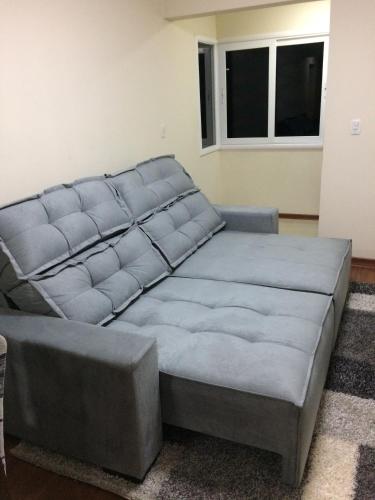 a large bed in a living room with at Apartamento Baviera in Canela