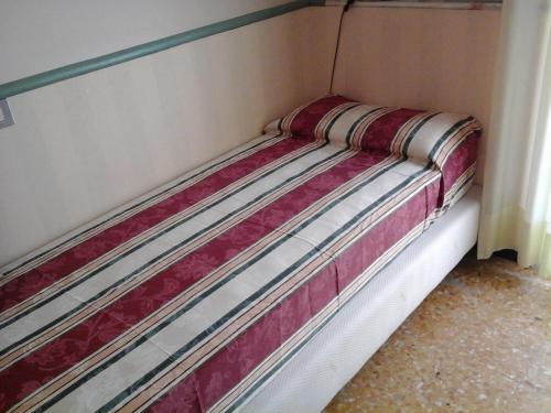 a bed in a corner of a room at Hotel Morchio Mhotelsgroup in Diano Marina