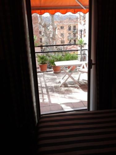an open door to a patio with a picnic table at Hotel Morchio Mhotelsgroup in Diano Marina