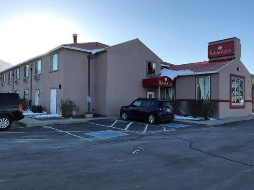 a car parked in a parking lot in front of a hotel at Ramada by Wyndham Draper, Utah in Draper