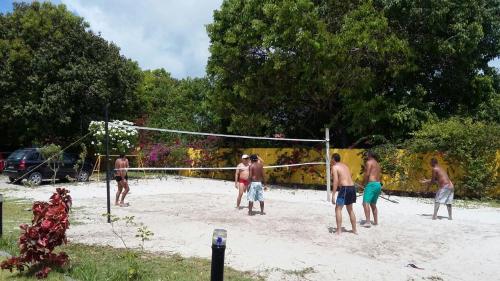 a group of men playing a game of volleyball at Pousada Recanto do Sossego in Itamaracá
