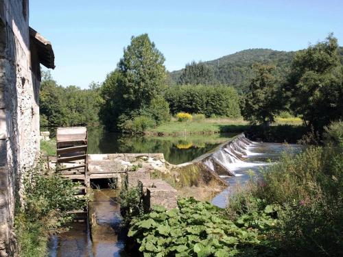 a bridge over a river next to at Apartment Gorska vila in Ogulin