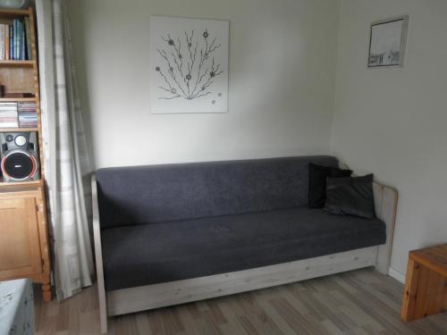 a couch in the corner of a living room at Holiday Home Kirkeby Feriehus in Roslev