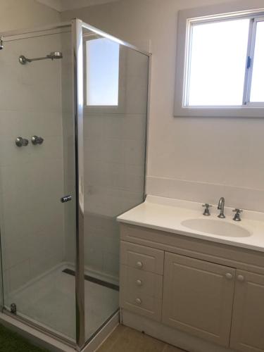 a bathroom with a shower and a sink at Best Beach Villa in Denham