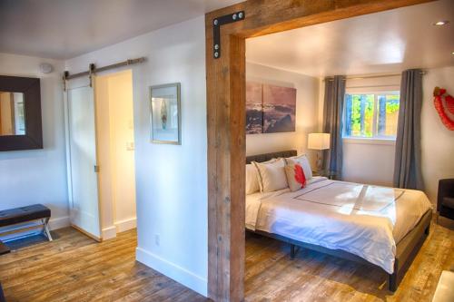 a bedroom with a large bed in a room at The Francis Boutique Inn in Ucluelet