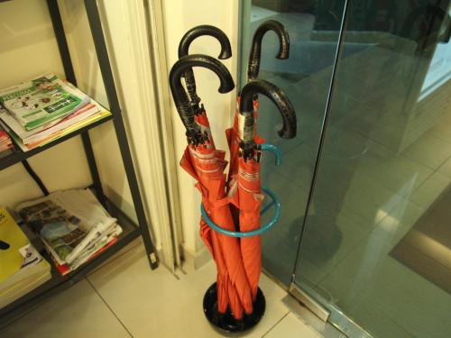 a group of umbrellas in a stand next to a door at Putra One Avenue Hotel in Seri Kembangan