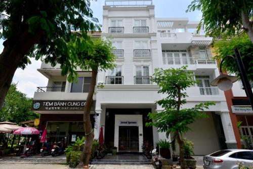 a white building with a sign in front of it at Phu My Hung - Saigon South Serviced Apartments - Near Vivo City Mall in Ho Chi Minh City