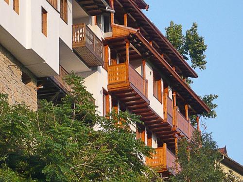 a building with wooden balconies on the side of it at Hotel Asenevtsi in Veliko Tŭrnovo