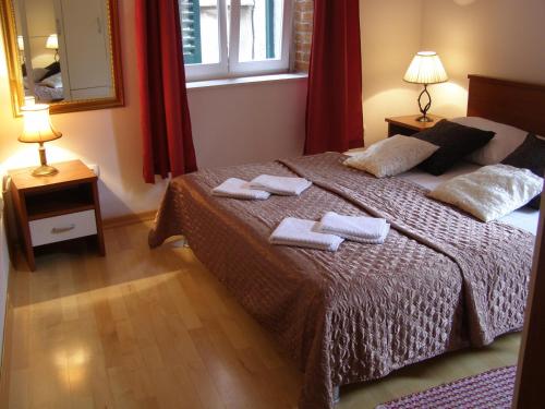 a bedroom with a bed with two towels on it at Split Artistic Apartments in Split