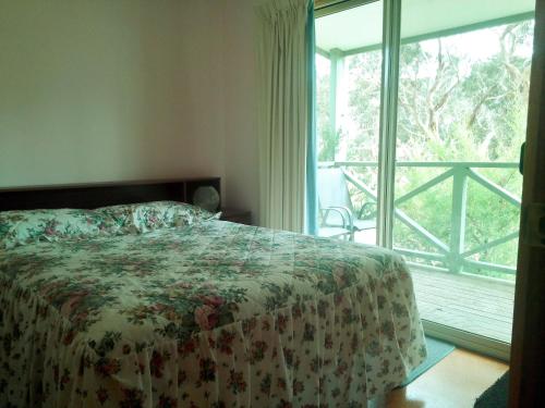 a bedroom with a bed and a large window at Wenton Farm Holiday Cottages in Middleton