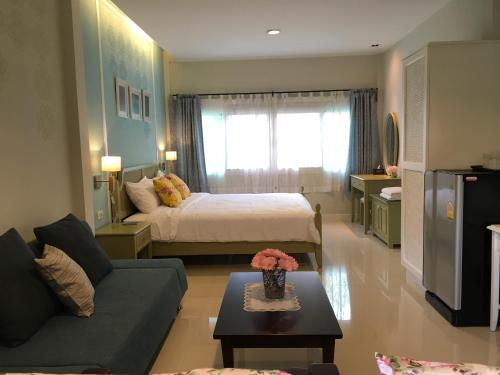 a living room with a bed and a couch at Bann Vimansamutr in Cha Am