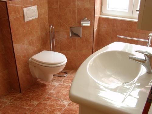 a bathroom with a toilet and a sink at Split Artistic Apartments in Split