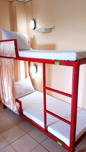 a bunk bed in a room with two bunk beds at Hua Hin Euro City Hotel in Hua Hin